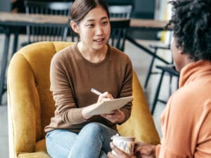 An in-person interview being conducted with a candidate and interviewer