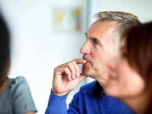 Shot of a group of colleagues listening to a presentation in an office