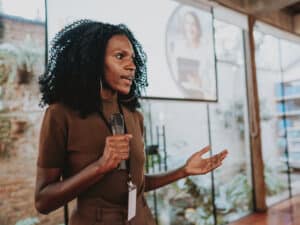 A woman giving a presentation with a microphone