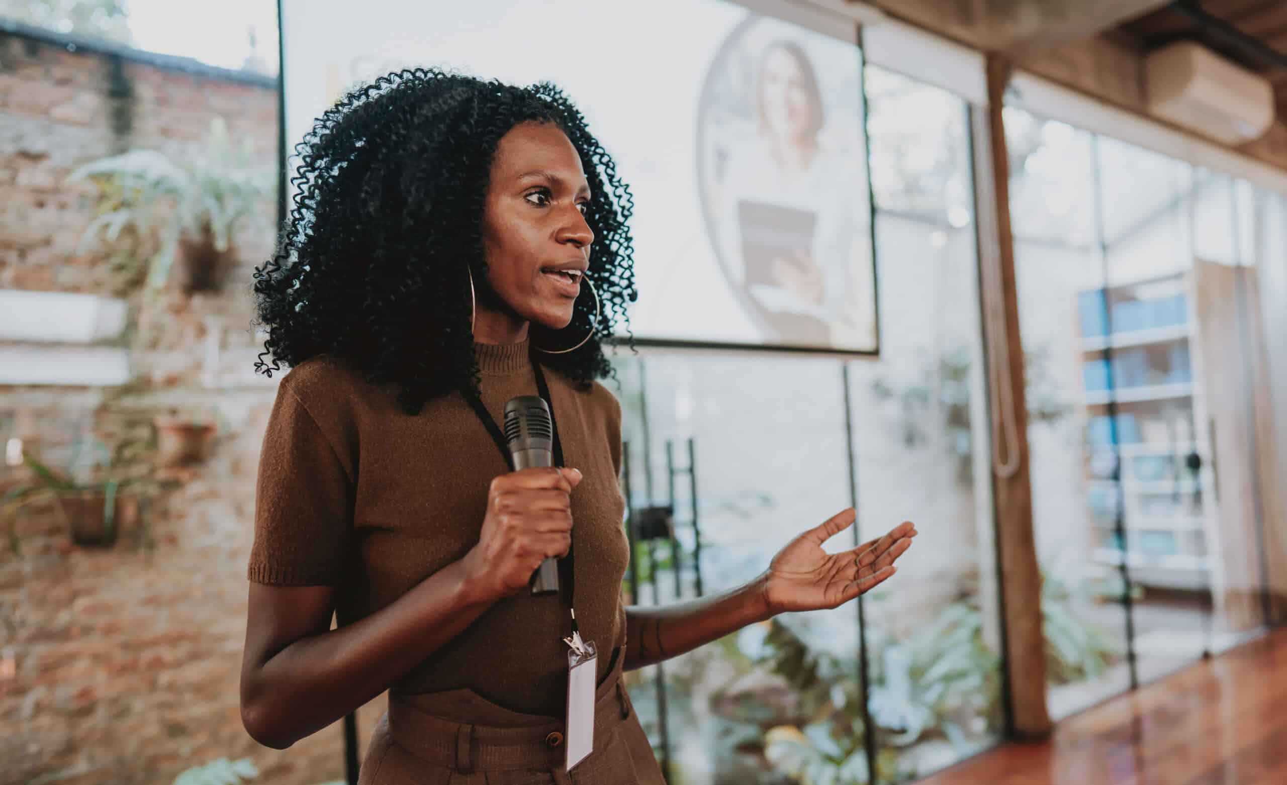 A woman giving a presentation with a microphone