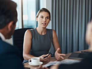 A business meeting in a grey toned corporate setting