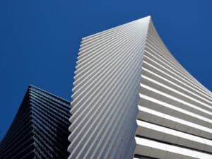 Bottom view of the black tower of skyscrapers Axis Towers Art Nouveau building against the backdrop of a beautiful clean sky