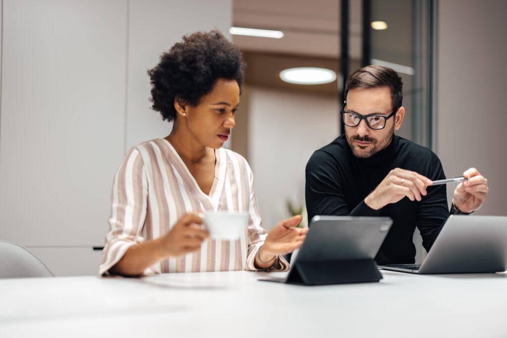 Adult man and a woman, joining a conference call on her tablet.