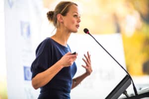business woman giving a presentation in a conference/meeting setting (shallow DOF; color toned image)