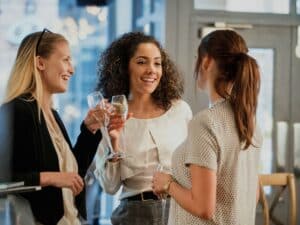 Three women networking and having champagne